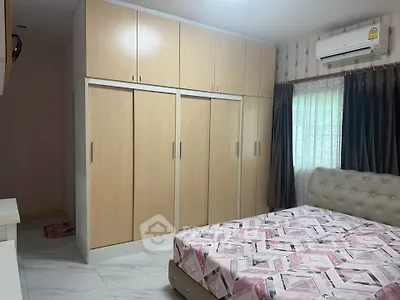 Cozy bedroom with built-in wardrobe and air conditioning, perfect for comfort and style.