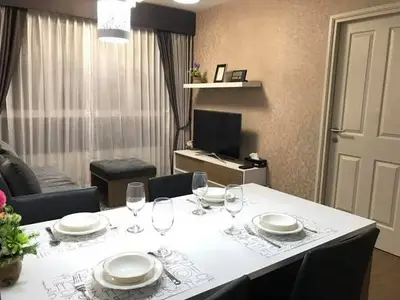 Elegant dining area with modern decor and cozy living room ambiance.