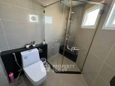 Modern bathroom with glass shower enclosure and sleek tile design