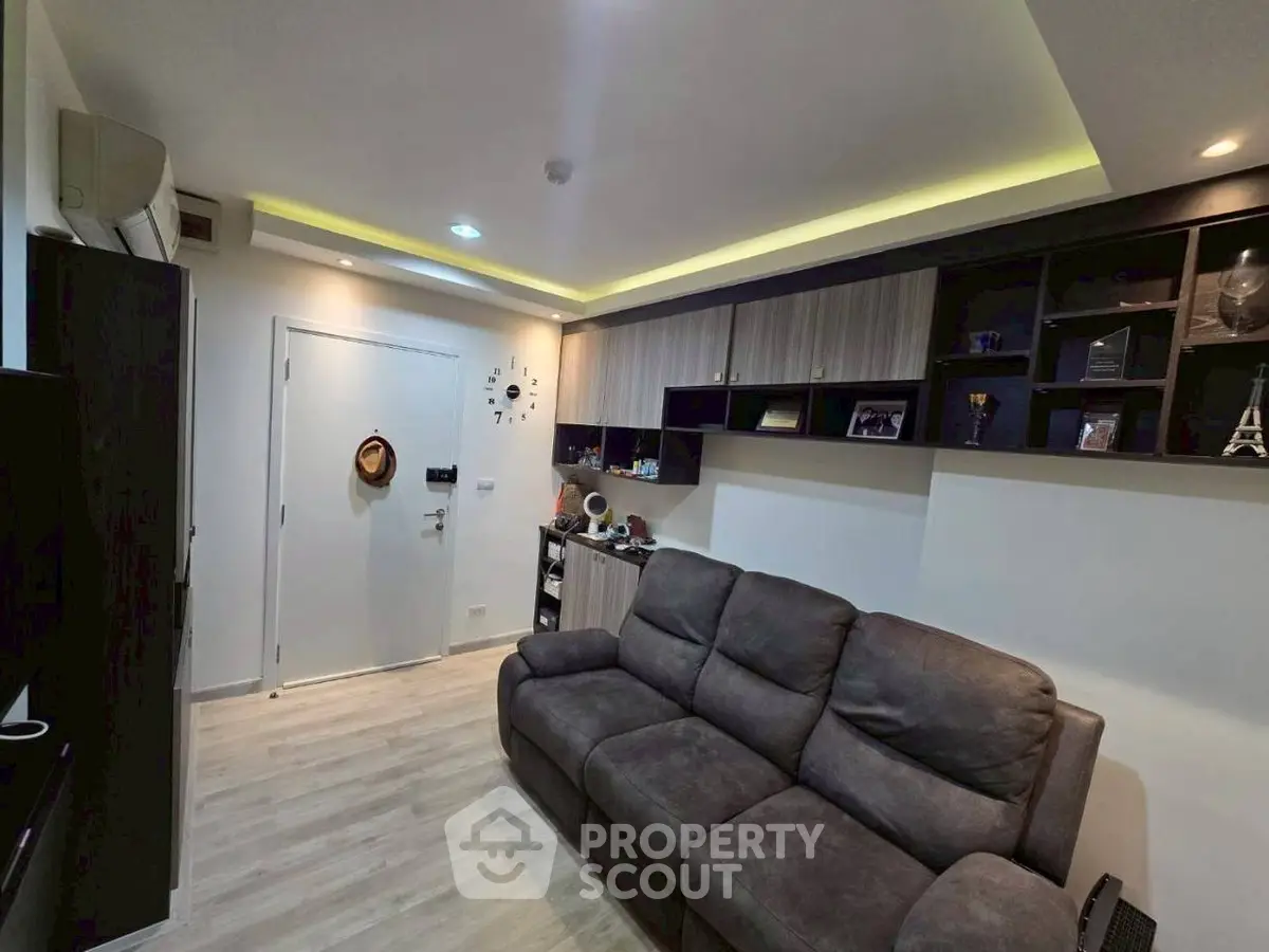 Modern living room with stylish shelving and cozy sofa in a contemporary apartment.