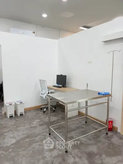 Modern office space with sleek metal desk and ergonomic chair, ideal for productivity.