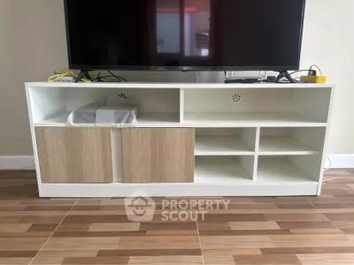 Modern living room with stylish TV stand and wooden flooring