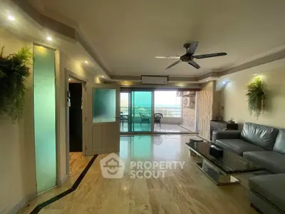 Spacious living room with modern decor and balcony view