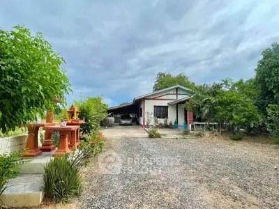 Charming countryside home with spacious driveway and lush greenery, perfect for serene living.