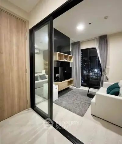 Modern living room with sleek design and city view, featuring a cozy sofa and stylish decor.