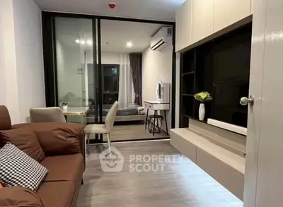 Modern living room with sleek furniture and open view into a stylish bedroom, perfect for urban living.