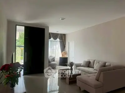 Spacious living room with modern sofa and elegant decor, perfect for relaxation.