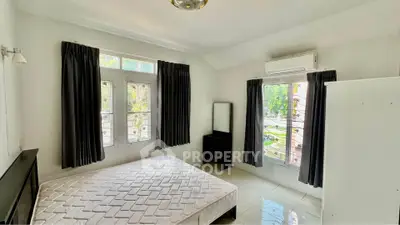 Spacious bedroom with large windows and air conditioning in modern apartment