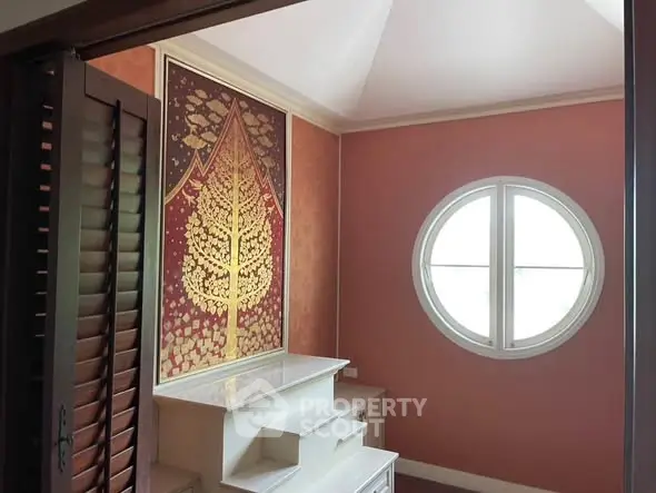 Charming room with unique round window and artistic wall design