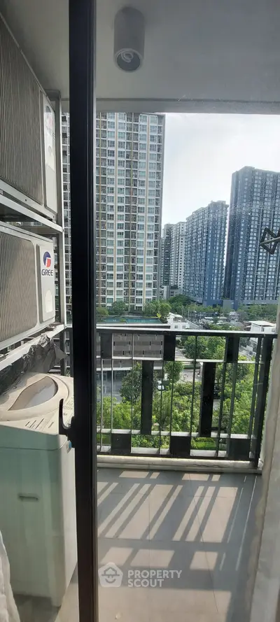 Modern balcony with city view and air conditioning unit, perfect for urban living.