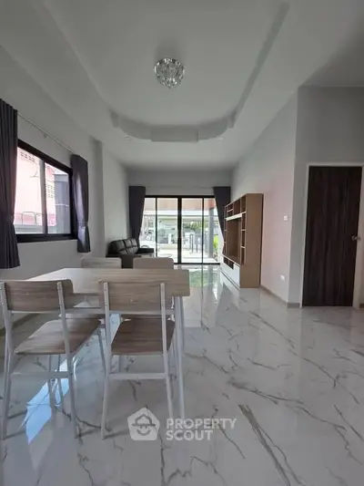 Spacious modern living room with marble floors and large windows