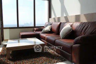 Luxurious living room with leather sofa and panoramic city view, perfect for relaxation and entertaining.