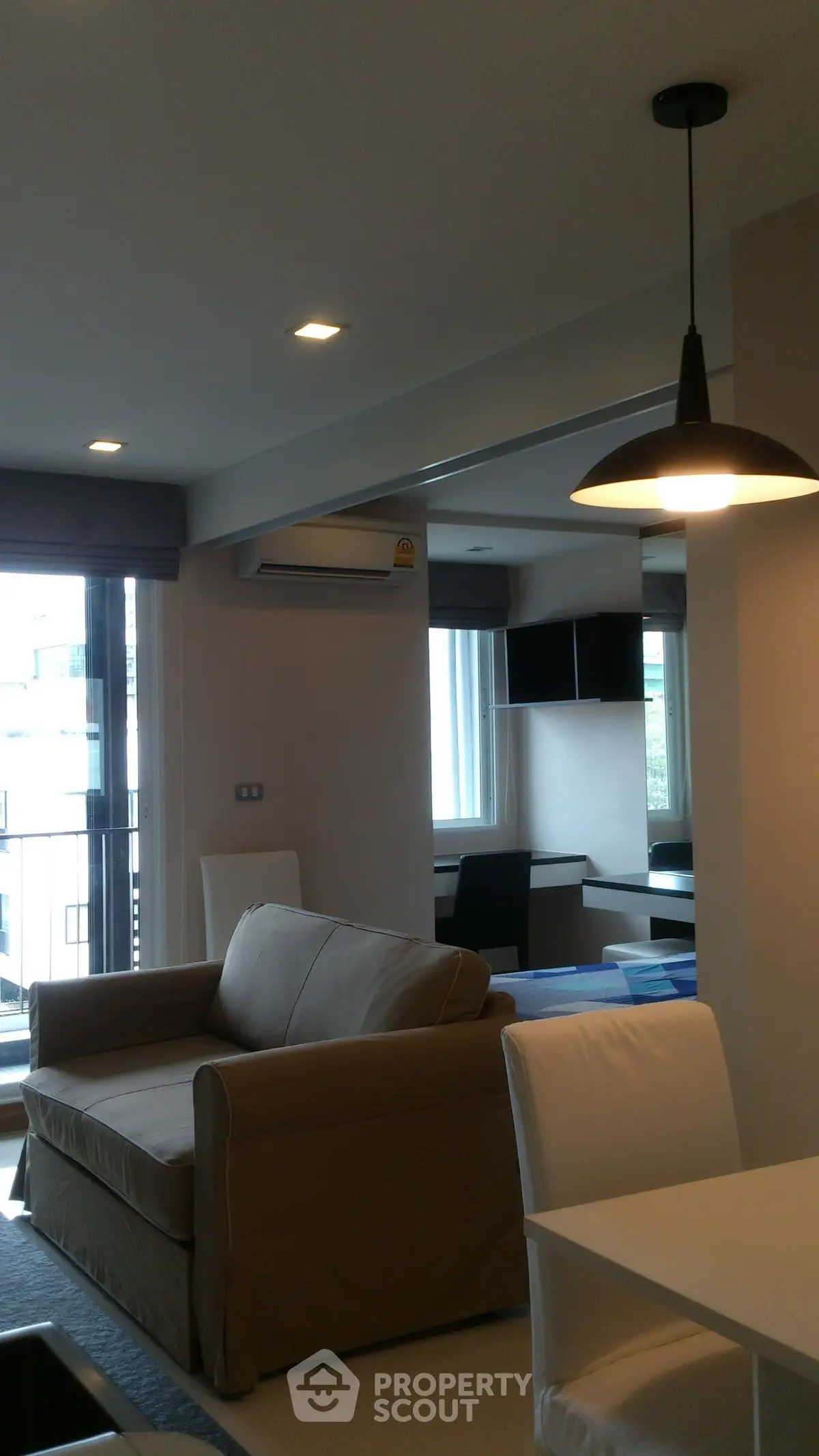 Modern living room with cozy sofa and stylish lighting in a bright apartment