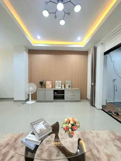 Modern living room with stylish decor, elegant lighting, and cozy furnishings for a welcoming ambiance.