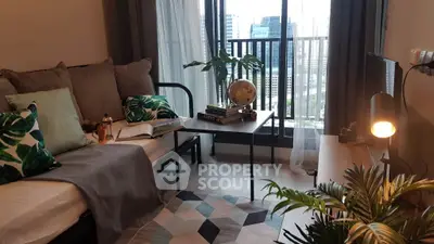 Stylish living room with city view, cozy sofa, modern decor, and large windows for natural light.
