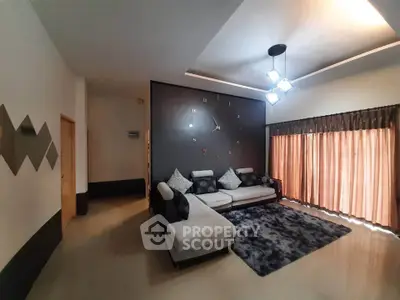 Spacious modern living room with stylish decor and large sofa, perfect for relaxation.