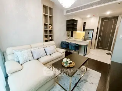 Modern living room with open kitchen, cozy sofa, and stylish decor