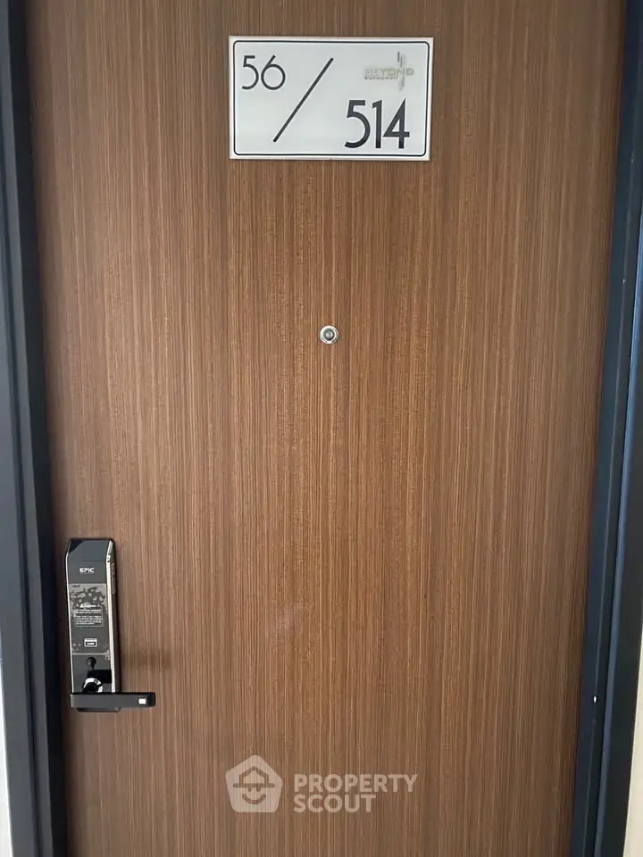 Modern apartment door with electronic lock and room number 514, showcasing secure entry.