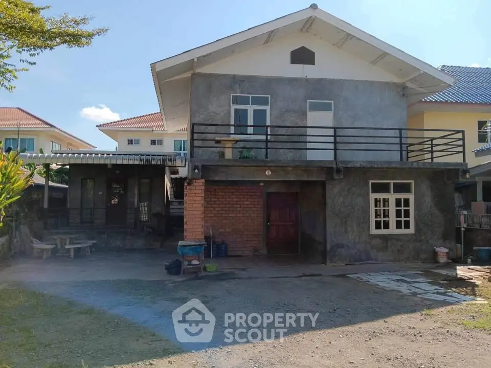 Charming two-story house with spacious driveway and rustic exterior in a serene neighborhood.
