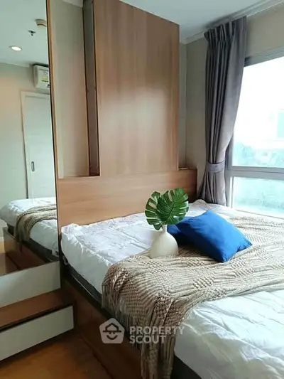 Cozy bedroom with modern decor and large window for natural light