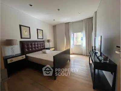 Spacious bedroom with modern furnishings and natural light