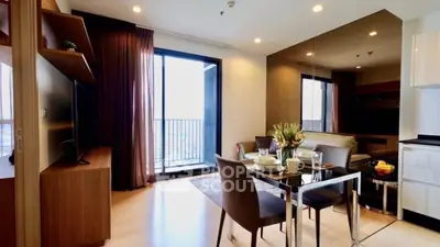 Modern living room with dining area and balcony access in a stylish apartment.