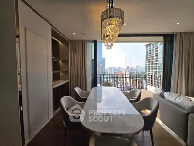 Luxurious dining area with city view and elegant chandelier in modern apartment