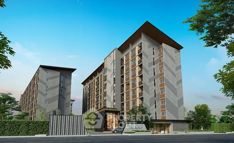 Modern apartment building exterior with lush greenery and clear blue sky.