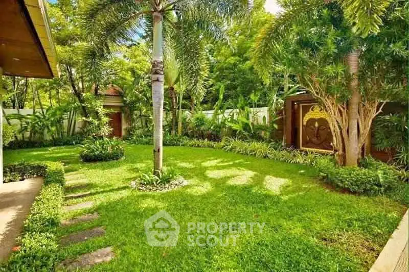 Lush tropical garden with vibrant greenery and palm trees, perfect for relaxation and outdoor enjoyment.