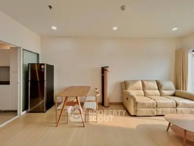 Spacious living room with modern furniture, ample natural light, and sleek hardwood flooring, perfect for comfortable urban living.