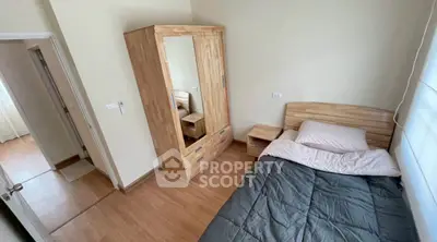 Cozy bedroom with wooden furniture and single bed in modern apartment.