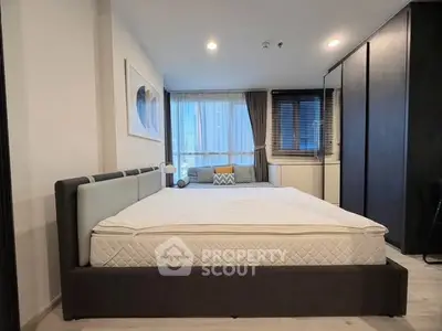 Modern bedroom with large bed and stylish decor in a contemporary apartment.