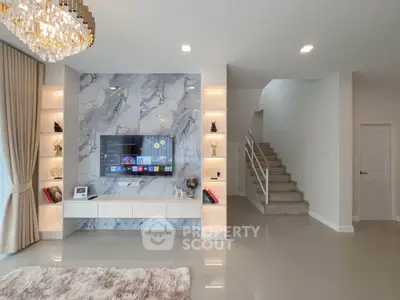 Luxurious living room with marble TV wall and elegant chandelier