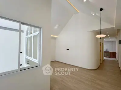 Spacious modern interior with high ceilings and sleek kitchen area