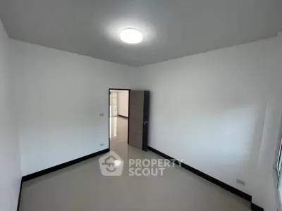 Spacious empty room with glossy tiled floor and modern lighting, ideal for customization.