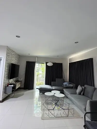 Modern living room with sleek gray sofa and stylish decor