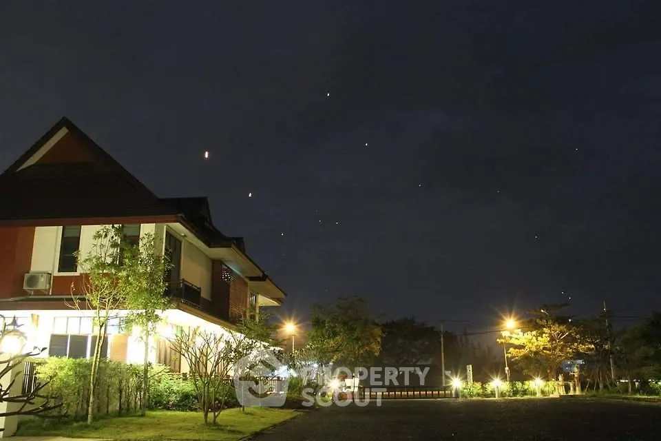Charming suburban house with lush garden under a starry night sky, perfect for serene living.