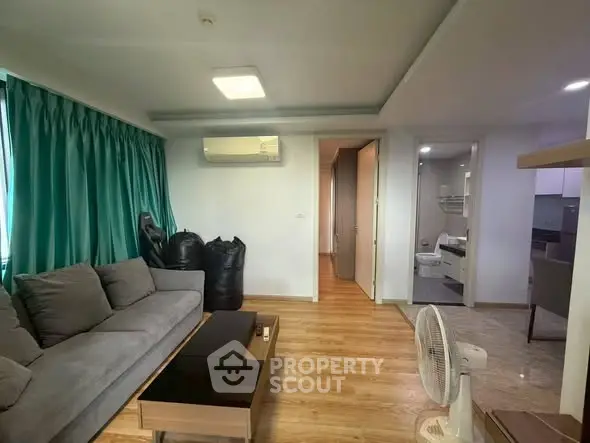 Spacious living room with modern decor and wooden flooring