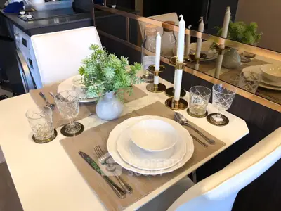 Elegant dining setup with white plates and crystal glasses in modern kitchen.