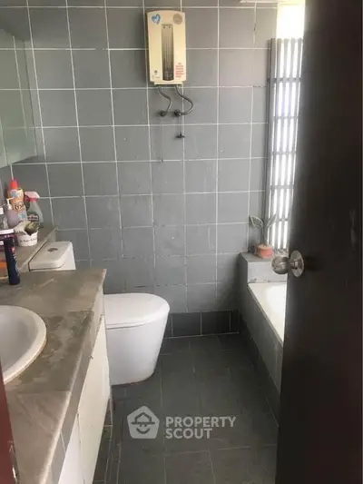 Cozy bathroom with modern fixtures and bathtub in a stylish apartment.