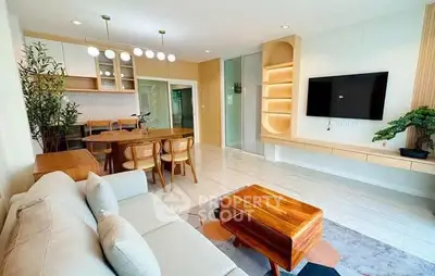 Modern living room with open layout, stylish furniture, and elegant lighting in a contemporary apartment.