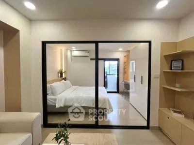 Modern bedroom with glass sliding doors and cozy decor