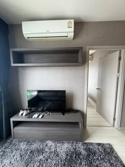 Modern living room with sleek entertainment center and air conditioning unit