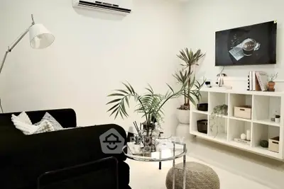 Modern living room with sleek black sofa and stylish decor