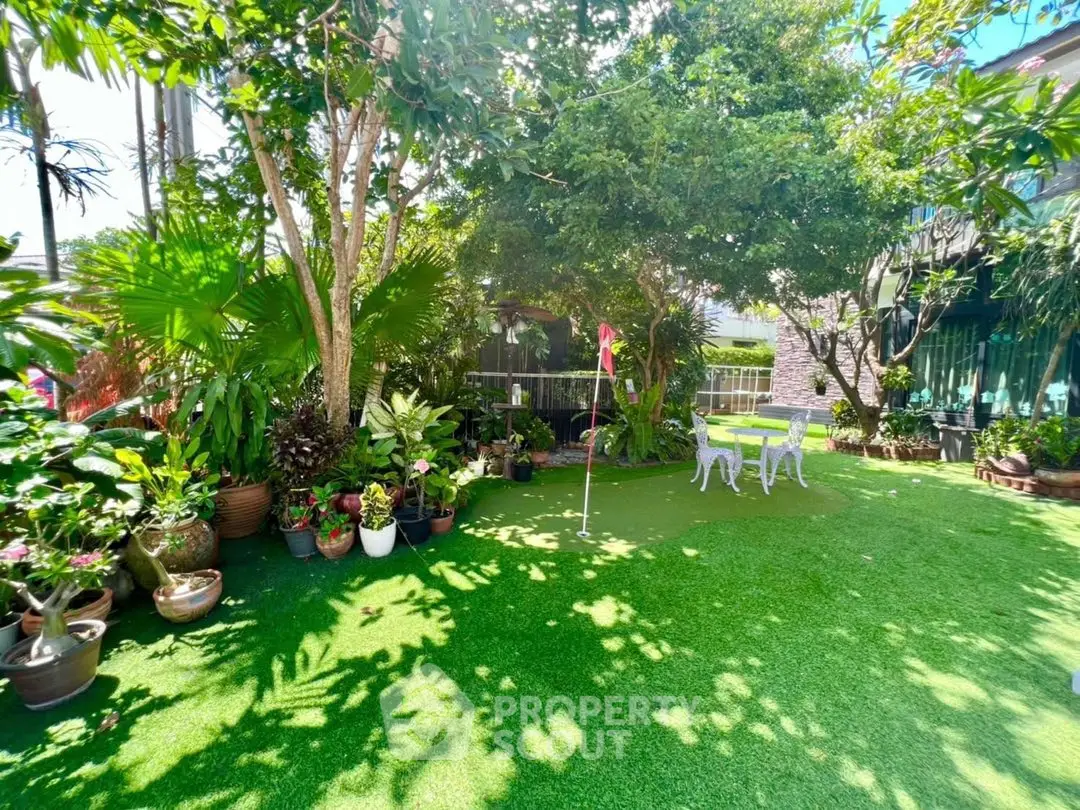 Lush garden with putting green and outdoor seating area