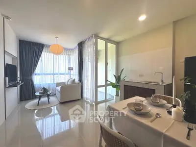 Modern open-plan living room and kitchen with elegant decor and natural light
