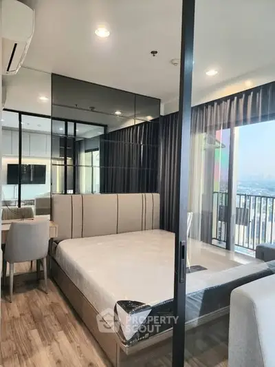 Modern bedroom with floor-to-ceiling windows and city view balcony