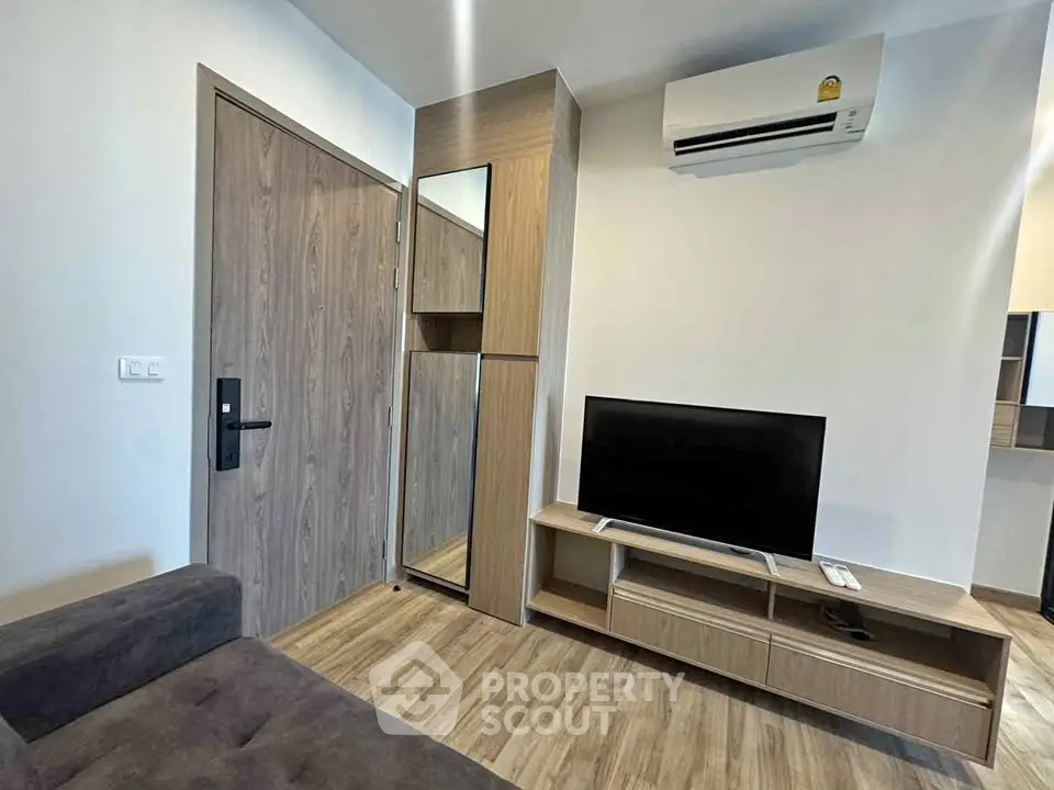 Modern living room with sleek wooden furniture and air conditioning unit, perfect for cozy urban living.