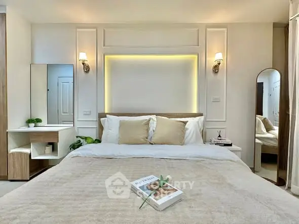 Luxurious bedroom with elegant decor and cozy ambiance, featuring a stylish bed and modern lighting.