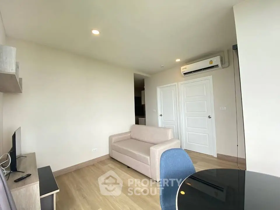 Modern living room with beige sofa and air conditioning in a bright apartment